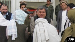 Kandahar Governor Tooryalai Wesa (facing camera) greets Taliban fighters as they surrender arms during a meeting with Afghan government officials as part of the government's peace and reintegration process in Kandahar on April 11.