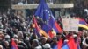 Armenia - An EU flag waved during an opposition rally in Yerevan, 1Mar2014.