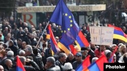 Armenia - An EU flag waved during an opposition rally in Yerevan, 1Mar2014.