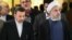 حسن روحانی (سمت راست) رئیس‌جمهوری ایران همراه با محمود واعظی، رئیس دفترش.