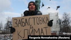 Arshak Makichyan holds a sign reading "Strike for climate" during a single-person demonstration in central Moscow in February 2020.