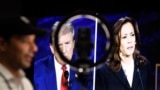 Journalists and members of the media watch from the spin room as US Vice President and Democratic presidential candidate Kamala Harris and former US President and Republican presidential candidate Donald Trump participate in a presidential debate at the N