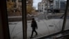 A photographer walks past buildings damaged by a Russian military strike in the town of Pokrovsk, Ukriane, on November 4.