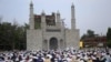 Muslims take part in Eid Al-Adha prayers in Jammu, Kashmir. 