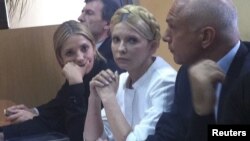 Former Ukrainian Prime Minister Yulia Tymoshenko (center) and her daughter Yevhenia (left) listen during a court session in Kyiv in September 2011.