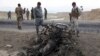 Afghan security forces gather at the site of Monday's suicide attack near the Bagram Air Base, north of Kabul, on April 9.