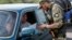 A Ukrainian serviceman checks documents at a checkpoint near Slovyansk in the Donetsk region.