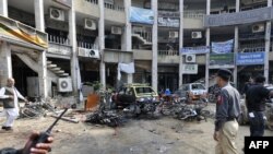 Pakistani policemen secure the site of a sucide bomb blast in Rawalpindi.