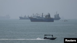 Vessels in the Strait of Hormuz are visible near the beach of Bandar Abbas.