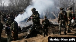 Indian Army soldiers arrive near the wreckage of an Indian aircraft after it crashed on the outskirts of Srinagar in India-controlled Kashmir on February 27.