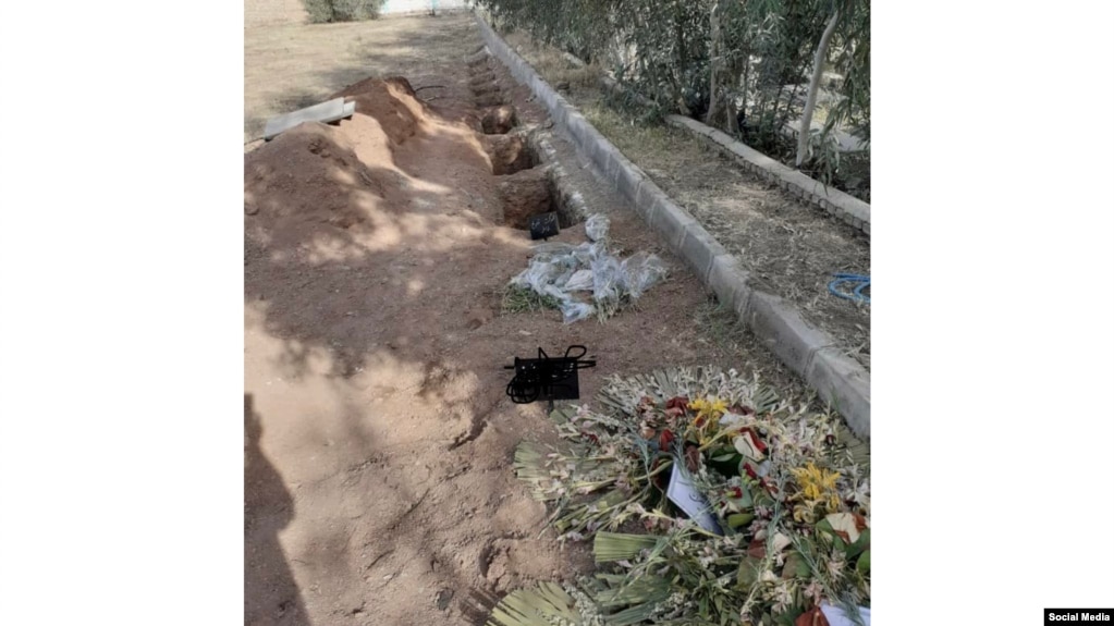 Several photos such as this one of the purported new graves at Khavaran, including two that had signs and flowers laid on them, have been posted online. 