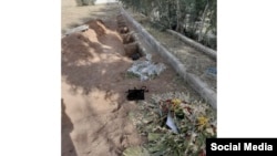 Several photos such as this one of the purported new graves at Khavaran, including two that had signs and flowers laid on them, have been posted online. 