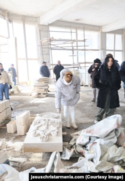 A February 2026 image of a group visiting the mountaintop construction site where the pedestal for the Jesus statue is being built