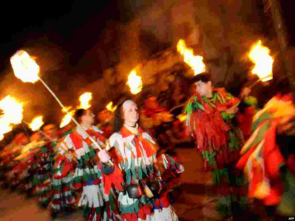 Bulgarians perform the traditional "Kukeri" dance, intended to drive away evil spirits, in the village of Gabrovdol. - Photo by AFP