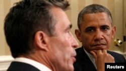 U.S. President Barack Obama watches as NATO Secretary-General Anders Fogh Rasmussen speaks in the Oval Office of the White House in Washington on May 31.