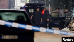 Emergency workers remove the body of one of the victims who died in a shooting rampage in the Montenegrin city of Cetinje on January 1. 