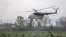 A Ukrainian military helicopter flies near a checkpoint near the eastern town of Slovyansk on May 2.