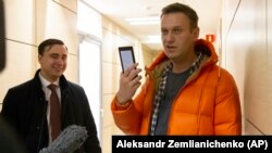 Aleksei Navalny (right) and Ivan Zhdanov speak to the media at the FBK office in Moscow on December 26, 2019.