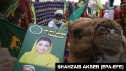 Supporters of opposition political party Pakistani Muslim League (Nawaz) hold a picture of leader Maryam Nawaz Sharif during an anti-government rally in Karachi on October 18.