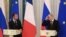Putin (right) and Macron give a joint press conference following talks outside St. Petersburg in May 2018.