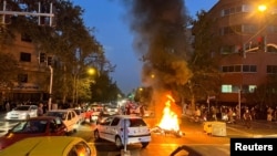 A police motorcycle burns during a protest in Tehran on September 19.