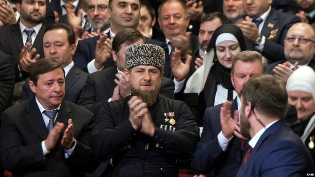 Ramzan Kadyrov (center) applauds after his inauguration ceremony for a third term in Grozny on October 5.