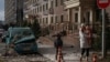 Residents walk past the site of a Russian drone strike in Odesa, Ukraine, on January 19.