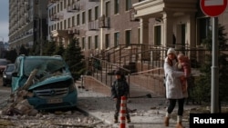 Residents walk past the site of a Russian drone strike in Odesa, Ukraine, on January 19.