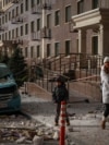 Residents walk past the site of a Russian drone strike in Odesa, Ukraine, on January 19.