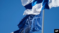 The NATO and Finnish flags flutter over the building of the Foreign Affairs Ministry in Helsinki.