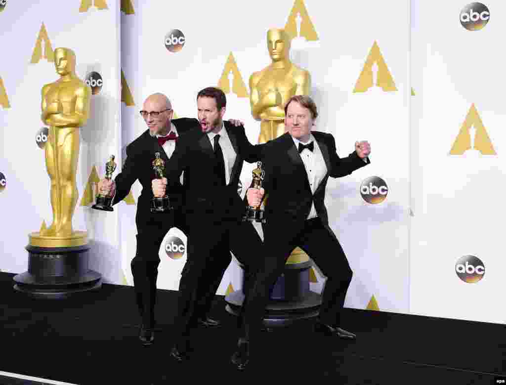 Roy Conti, Chris Williams and Don Hall strike a pose with their awards for Best Animated Feature Film (Big Hero 6).