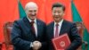 Chinese President Xi Jinping (right) shakes hands with Alyaksandr Lukashenka at a signing ceremony during the Belarusian leader's visit to Beijing in 2016. 
