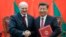 Chinese President Xi Jinping (right) shakes hands with Alyaksandr Lukashenka at a signing ceremony during the Belarusian leader's visit to Beijing in 2016. 