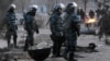 Kazakh riot police patrol in the town of Zhanaozen on December 18. Locals say the number of dead from the December 16 violence is being deliberately under-reported.