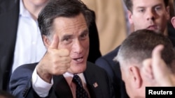 Mitt Romney gives a thumbs-up after addressing supporters on primary night in Michigan.