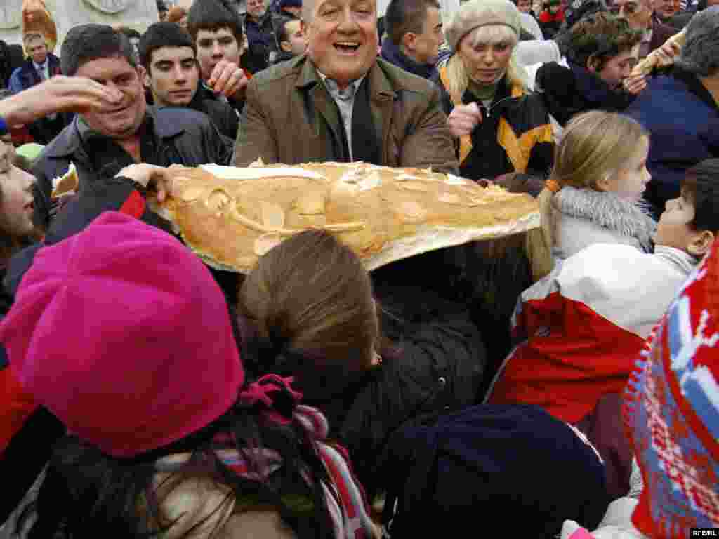 FOTO: Vesna Anđić - Božićna česnica sa tri zlatnika, teška više od 40 kilograma, podeljena je građanima na platou kod Terazijske česme u Beogradu. Zlatnike u česnici pronašle su petogodišnja Jana Mitrović, devetogodišnja Doroteja Joksović i dvadesetosmogodišnja Jovana Mirković. 