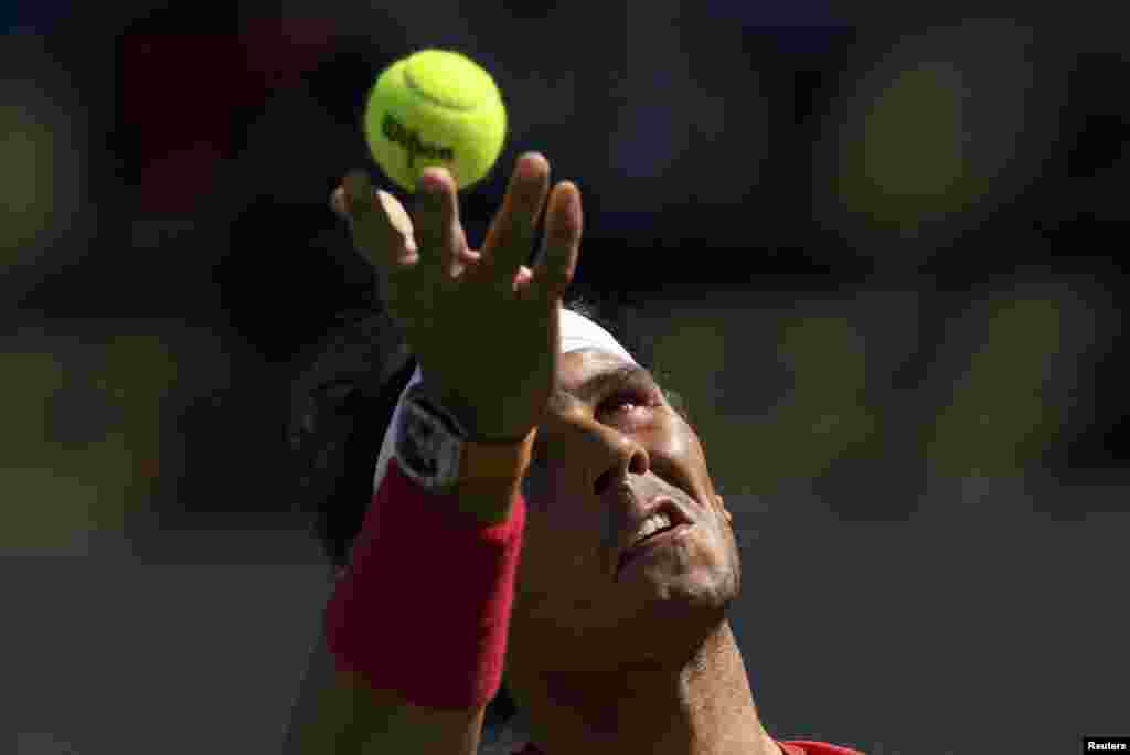 Rafael Nadal of Spain serves during a warm-up session before his tennis match against Gilles Simon of France.