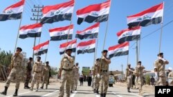 Iraqi Shi'ite volunteers who have joined government forces to fight Sunni jihadists from the Islamic State take part in a training session near the southern port city of Basra.