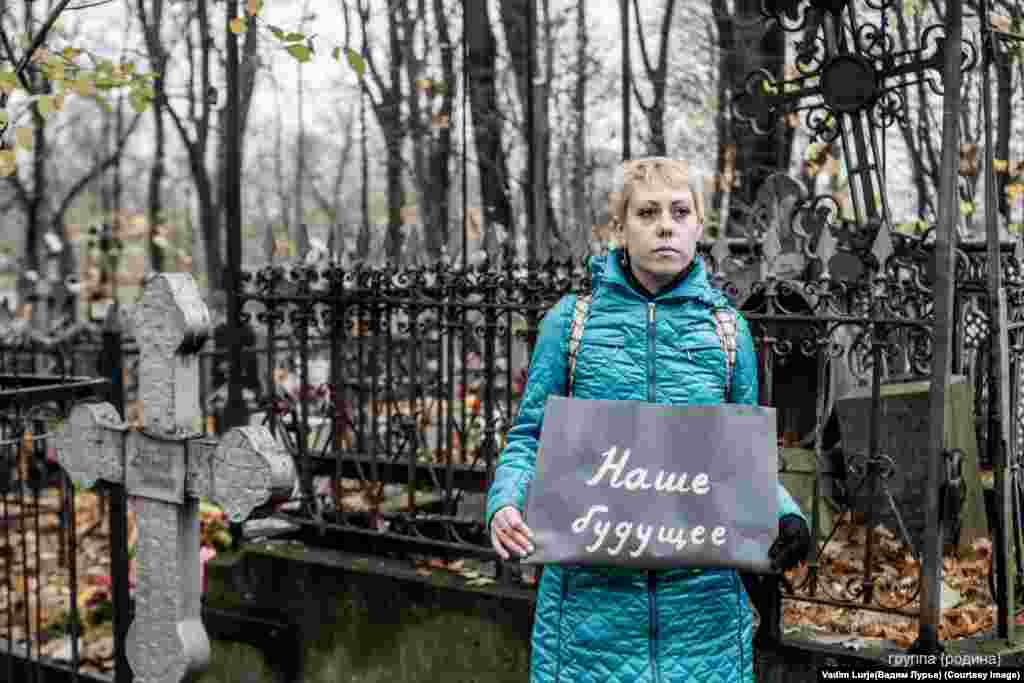 &quot;Our future.&quot; The artists held their signs in cemeteries, at railway stations, in parks filled with fallen leaves, and next to trash bins. 