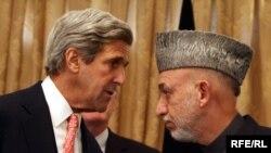 U.S. Senator John Kerry (Democrat, Massachusetts) talks with Afghan President Hamid Karzai in Kabul last year.