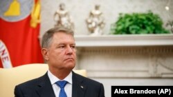 U.S. -- Romanian President Klaus Iohannis listens as President Donald Trump speaks in the Oval Office of the White House, Washington, August 20, 2019