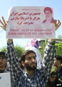 Iranian protestors, mainly members of the Basij Islamic militia, holds up a sign during a protest against the war in Iraq 12 April 2003, for the sixth consecutive day outside the British embassy in Tehran. AFP PHOTO/HENGHEMEH FAHIMI