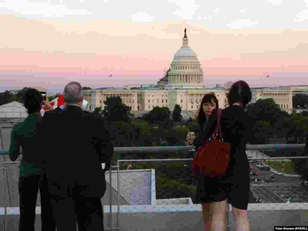 Reception attendees enjoy a bird's eye view of the U.S. Capitol from the 8th floor terrace at the Newseum in Washington, DC.