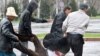 Protesters carry a victim of the security forces' crackdown on the crowd outside the main government building in Bishkek on April 7, 2010, when officials say 87 people died.