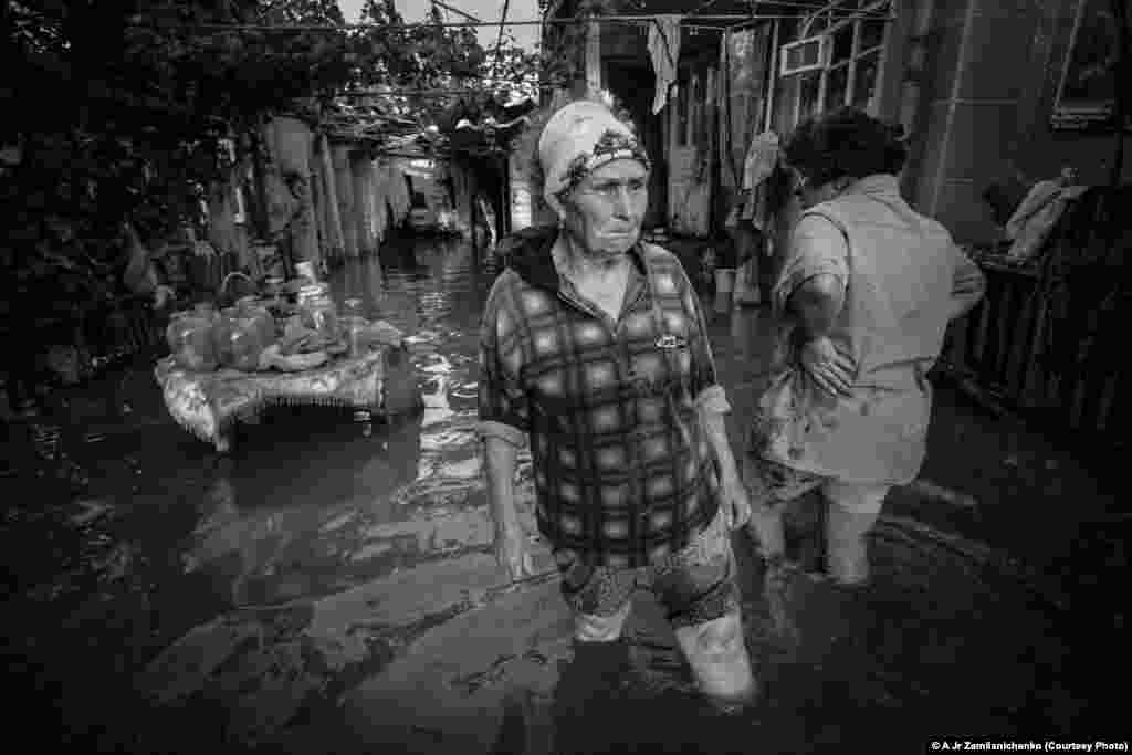 Photographer Alexander Zemlianichenko Jr. of Russia took this shot of a woman crying as she walks in front of her flooded house in Krymsk, Russia.