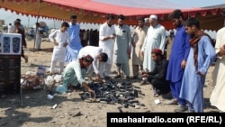 Pashtun Tahafuz Movement activists collect empty tear gas cannisters on October 2, the day after a police raid on their jirga camp.