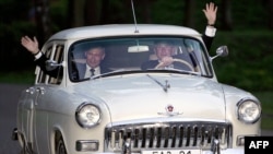 U.S. President George W. Bush drives Vladimir Putin's 1956 Volga, outside Moscow, in May 2005.