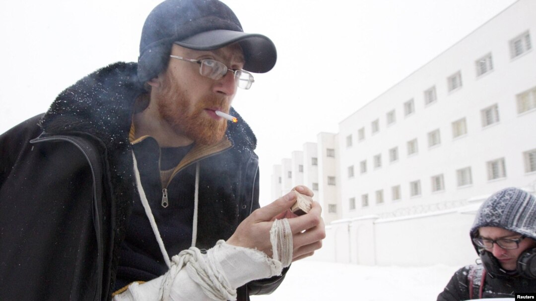 Opposition activist Yan Logvinovich smokes a cigarette after he was released from a detention center in Minsk on December 29.