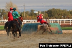 A Kyrgyzstan player hoists a synthetic goat carcass, a tai-kazan, into the goal during a dominant 12-0 victory over Uzbekistan in the early rounds of the Kok Boru competition on September 9.