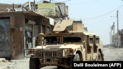 A US-made military vehicle used by the Syrian Democratic Forces (SDF), an American-backed Kurdish-Arab alliance, drives through an eastern area of the embattled Syrian city of Raqqa, August 15, 2017